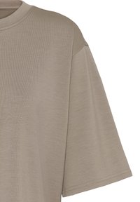 Beżowy, bawełniany T-shirt z krótkim rękawem, prążkowanym okrągłym dekoltem i przeszyciem na ramieniu.