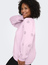 Pink sweatshirt with puffed sleeves, decorative eyelet cutouts on sleeves, and ribbed cuffs. Smooth fabric and relaxed fit.