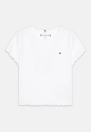 Vit bomulls t-shirt med rund halsringning, korta ärmar och vågig nederkant. Har en liten logotyp på vänster bröst.