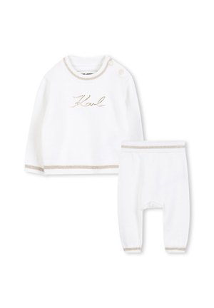 Ensemble en tricot blanc composé d'un haut à manches longues avec broderies dorées et accents crème, associé à un pantalon assorti avec des poignets élastiques.