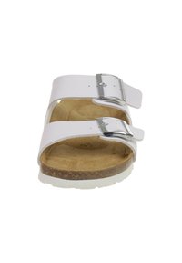 White sandal with two adjustable straps, silver metal buckles, and a light brown cork footbed. White outsole with textured surface.