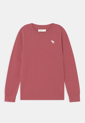 T-shirt enfant à manches longues rose poussiéreux avec un petit logo élan blanc sur la poitrine gauche et un col rond.