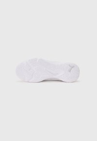 Semelle de chaussure de sport blanche avec des motifs de grip texturés et un détail circulaire central ; matériau en caoutchouc lisse avec accent de logo.