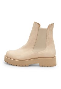 Botine din piele bej, cu panouri elastice pe laterale, vârf rotunjit și o talpă din cauciuc robustă, cu un model texturat.