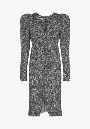 Robe midi noire à petits imprimés floraux blancs, manches longues bouffantes, légère fente sur le devant et encolure en V avec détails de taille froncée.