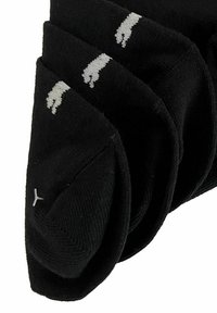 Schwarze Socken mit einem gerippten Textur, die weiße Logos nahe den Bündchen aufweisen. Das Design ist schlicht und funktional, mit einer klassischen Form.