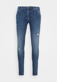 Skinny-fit blue jeans made of denim, featuring distressed details with rips, five-pocket design, and a button-fly closure.