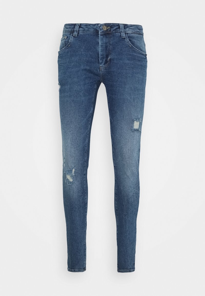 Skinny-fit blue jeans made of denim, featuring distressed details with rips, five-pocket design, and a button-fly closure.