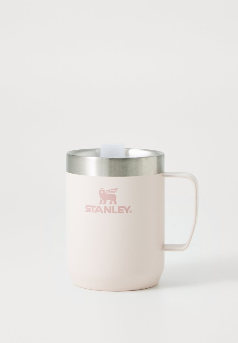 Light pink stainless steel mug with a rounded shape, a silver rim, and a handle. Features a logo and a flat, square lid opener.
