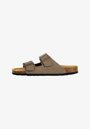 Sandale slide marron avec deux brides réglables à boucle, lit de pied en liège et semelle texturée noire, vue de profil sur fond blanc.