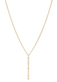 Gold-tone pendant necklace with a chain. Features geometric cutouts and clear stones, creating a linear drop design.