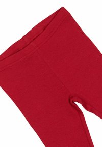 Leggings rojos con textura suave y cinturilla elástica. Presentan un ajuste ceñido alrededor de las piernas sin patrones ni adornos adicionales.