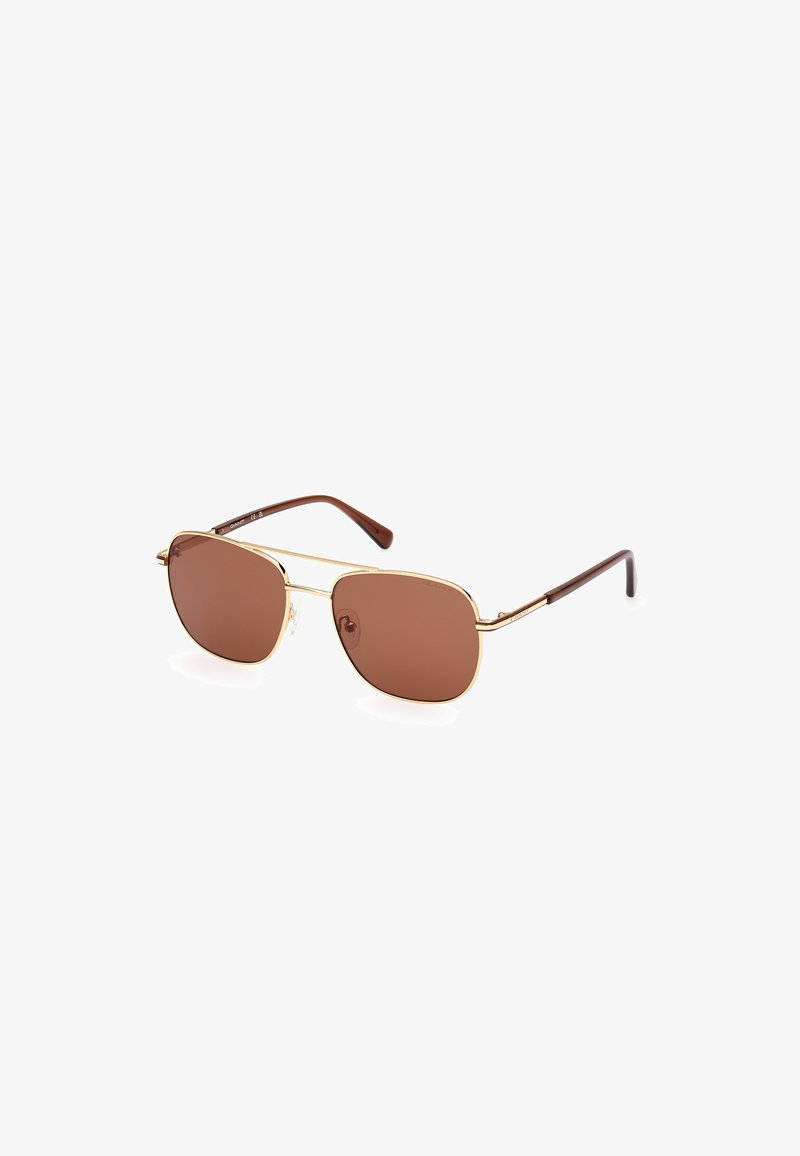 Brown tinted sunglasses with a gold metal frame, rounded lenses, and brown plastic temples. Features a subtle logo on one lens.