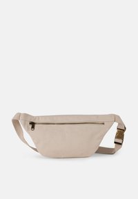 Belt bag in beige canvas with a zippered front pocket and adjustable strap. Features a smooth texture and minimal design.