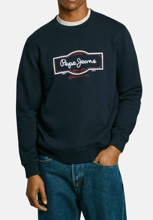 Navy blue sweatshirt made of cotton, featuring a prominent white and red logo design. Ribbed cuffs and hem with a relaxed fit.
