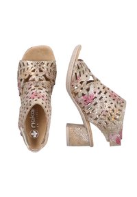 Open-toe heeled sandals with floral cutouts, metallic gold and pink textures, low block heel, and cushioned insole. Adjustable ankle strap.