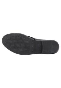Semelle de chaussure en caoutchouc noire avec un motif texturé et rainuré, de forme arrondie, et section de talon renforcée, portant l'étiquette de taille "38".