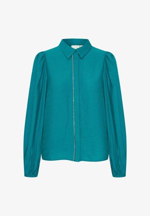 Tummansininen paita, jossa on pitkät puff-hihat, kauluksellinen kaula-aukko ja nappikiinnitys, jossa on hienovarainen koristeellinen reuna. Sujuva kankaan pinta.