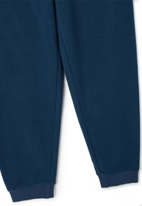 Pantalones de chándal de felpa azul marino, con una textura suave, puños elásticos y un diseño holgado. Adecuados para el uso casual o descansar.