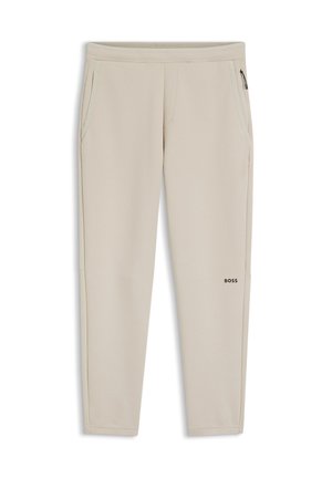 Pantalon de jogging beige coupe slim avec taille élastique, poches latérales, poche zippée sur la cuisse droite et logo "BOSS" sur la cuisse gauche.