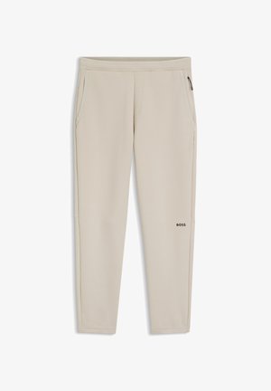 Pantaloni jogger beige aderenti con vita elasticizzata, tasche laterali, tasca con zip sulla coscia destra e logo "BOSS" sulla coscia sinistra.