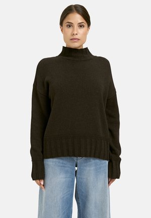 Dark brown knitted sweater with a high collar, ribbed cuffs, and hem. The design features a relaxed fit and textured fabric.