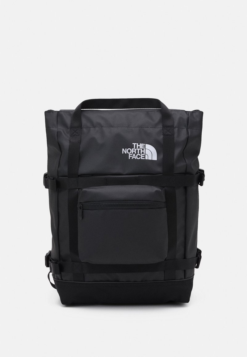 Sac à dos rectangulaire noir North Face avec poignées supérieures, poche avant zippée, sangles latérales réglables et logo sur le panneau avant supérieur.