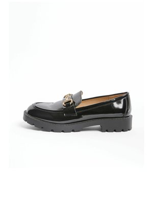 Black patent leather loafer with chunky sole and gold buckle detail, shown in side view on white background.