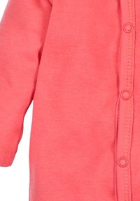 Coral-colored baby onesie with long sleeves, soft cotton fabric, front snap buttons, and ribbed cuffs. Simple, solid design without patterns.