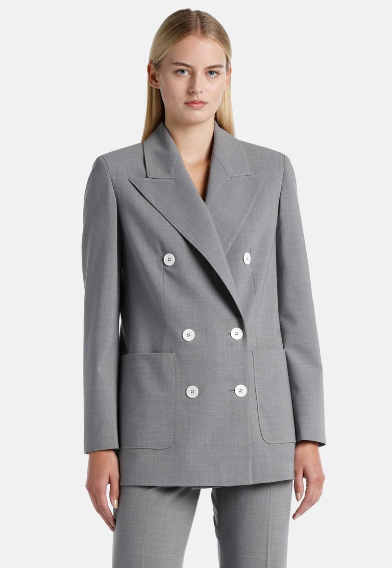 Grey double-breasted blazer made of textured fabric, featuring white buttons, large front pockets, and sharp lapels.