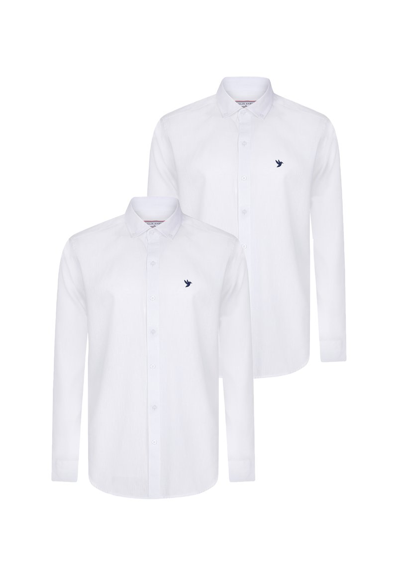 Camisas blancas de manga larga con cuellos abotonados, que presentan un pequeño logotipo de un pájaro en navy en el pecho y una tela suave y texturizada.