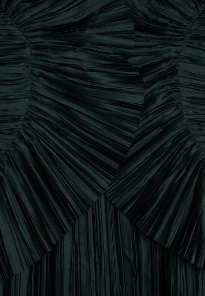 Dark green pleated fabric with a textured appearance, featuring curved sections with layered, gathered pleats. Smooth finish, soft texture.