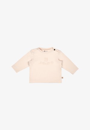 Long-sleeve light beige shirt in soft cotton, featuring a pink embroidered cartoon animal design on the front and black snap fasteners on the shoulder.