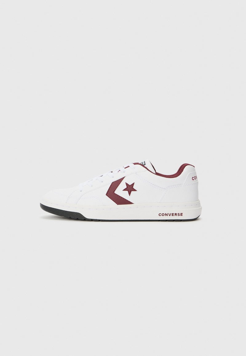 White low-top sneakers with maroon accents, including a star logo and side stripe. Features a textured upper and rubber sole.
