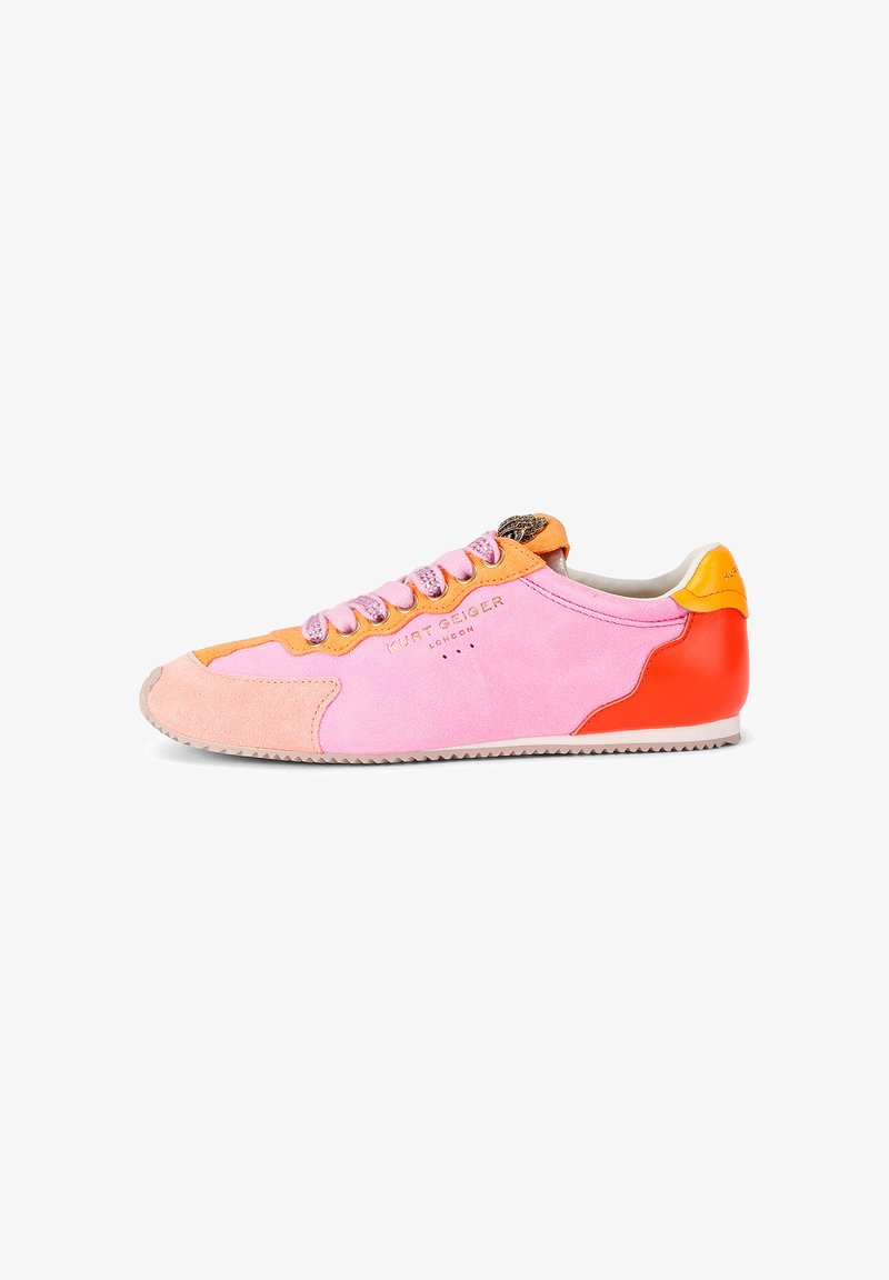 Low-profile sneaker with pink suede, orange accents, red heel, and pink laces, viewed from the side on a white background.