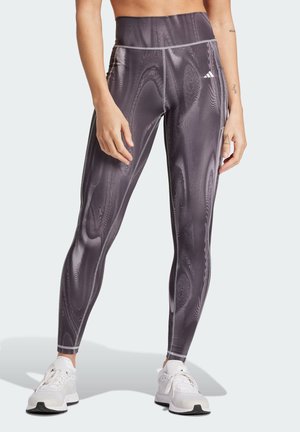 High-waisted athletic leggings in dark gray with a textured, swirling pattern. Features contrasting seams and an Adidas logo on the waist.