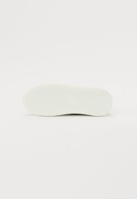 White rubber shoe sole with textured grip pattern and rounded edges, flat design, smooth surface without additional details or patterns.
