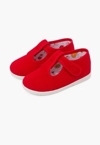 Scarpe da ginnastica rosse in tela con chiusura a strappo, suole in gomma bianca e un interno decorato con disegni colorati di cartoni animati.