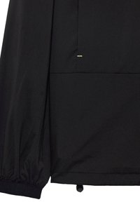 Black lightweight jacket with elastic cuffs, featuring a front pocket and subtle yellow stitching detail. Smooth texture, streamlined design.