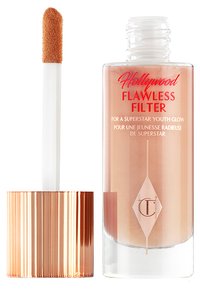 Bottiglia di vetro con un liquido di tonalità rosa, dotata di un tappo in rosa oro dalla texture particolare. Include un applicatore con punta a teardrop per un uso facile.