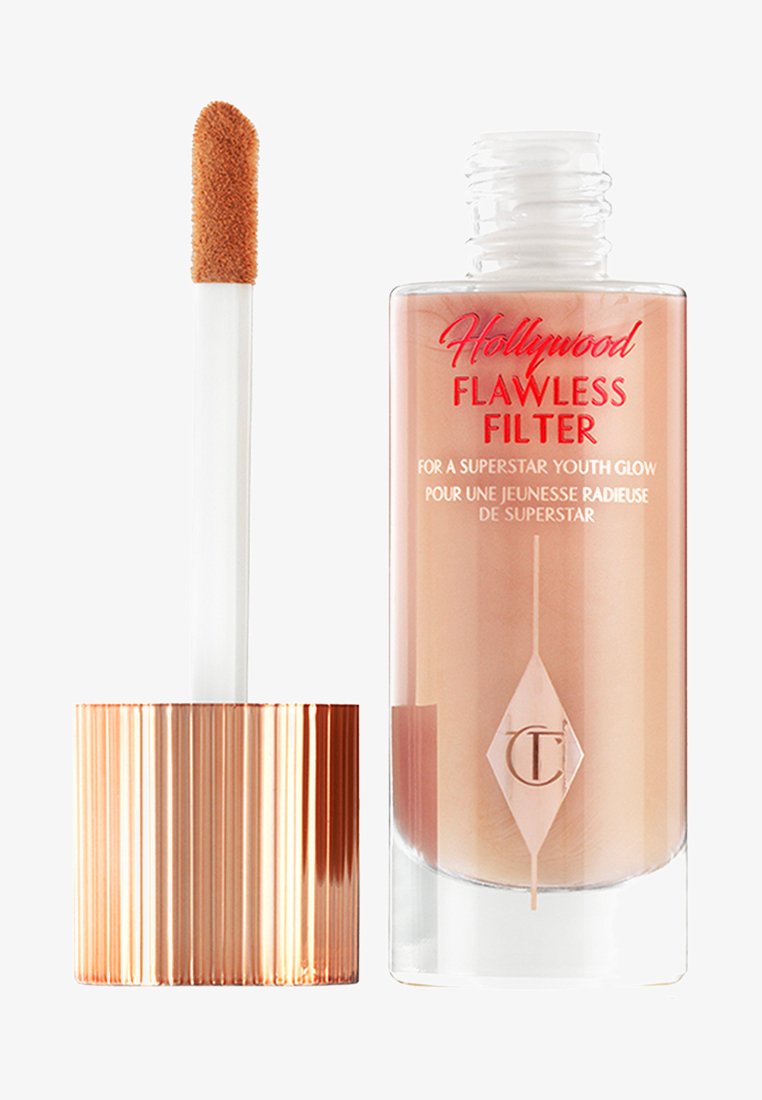 Bottiglia di vetro con un liquido di tonalità rosa, dotata di un tappo in rosa oro dalla texture particolare. Include un applicatore con punta a teardrop per un uso facile.