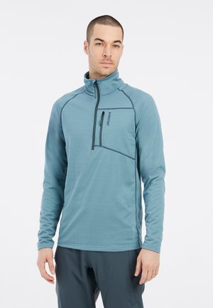 Felpa chiusa con zip di colore azzurro chiaro, con maniche lunghe, caratterizzata da un colletto alto, una tasca sul petto e dettagli di cucitura scuri a contrasto.