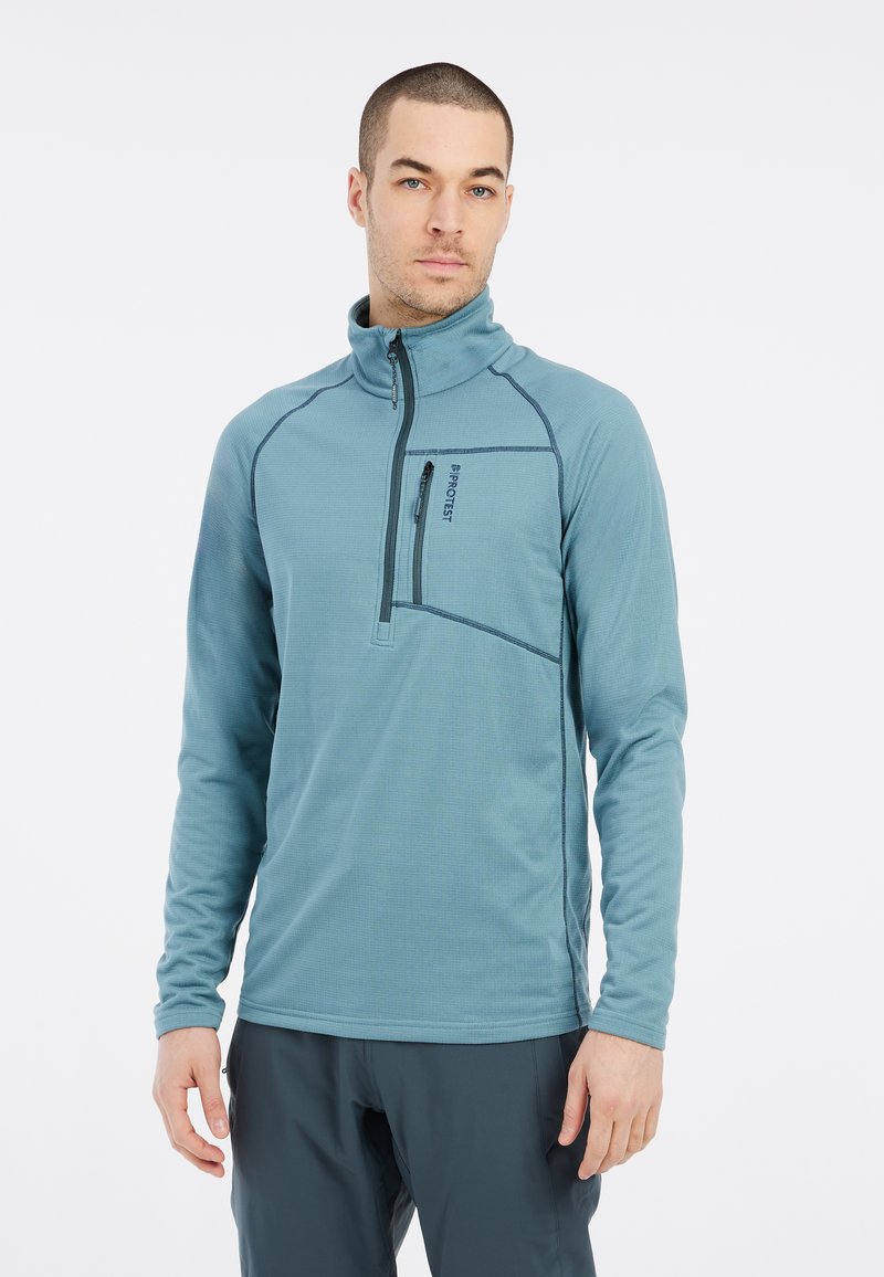 Felpa chiusa con zip di colore azzurro chiaro, con maniche lunghe, caratterizzata da un colletto alto, una tasca sul petto e dettagli di cucitura scuri a contrasto.
