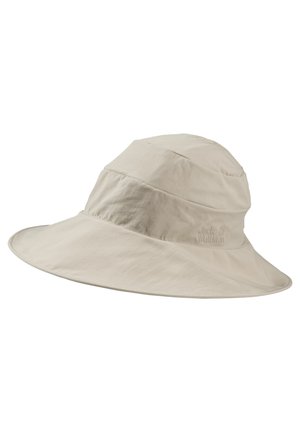 Chapeau de soleil beige clair à large bord en tissu doux, avec des coutures discrètes et un logo de marque embossé sur le côté.