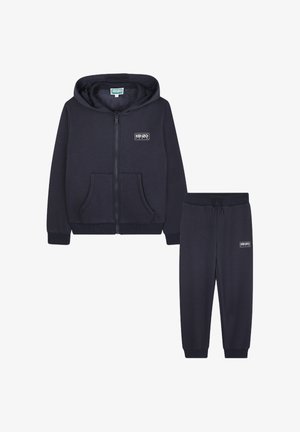 Navy blue zip-up hoodie with a drawstring hood and front pockets, paired with matching jogger pants featuring an elastic waistband and logo.