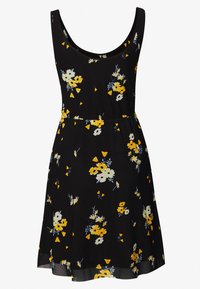 Svart ärmlös klänning med ett blommönster som har gula och vita blommor samt blå accenter. Utställd kjol med en flödande textur.