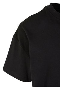 Black cotton t-shirt with a round neckline, short sleeves, and a smooth texture. Features a relaxed fit and clean stitching at the hem.