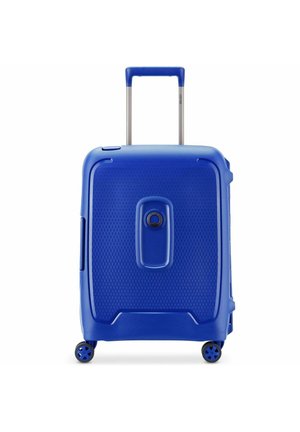 Hard-shell blue suitcase with textured surface. Features a retractable handle, a combination lock, and four spinner wheels for mobility.