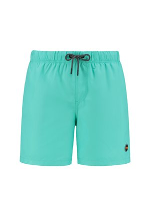 Turkise badetights lavet af letvægtsstof. Har en elastisk talje med en sort snor og en lille logo-patch på siden.