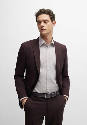 Burgundy suit jacket with notched lapels, paired with a light gray striped shirt and a black belt featuring a silver buckle.